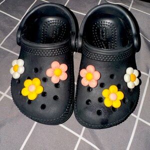 Black C5 Crocs - with flower charms can be removed.